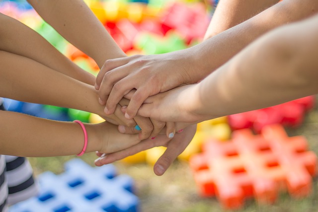 People in a circle with hands on top of each other