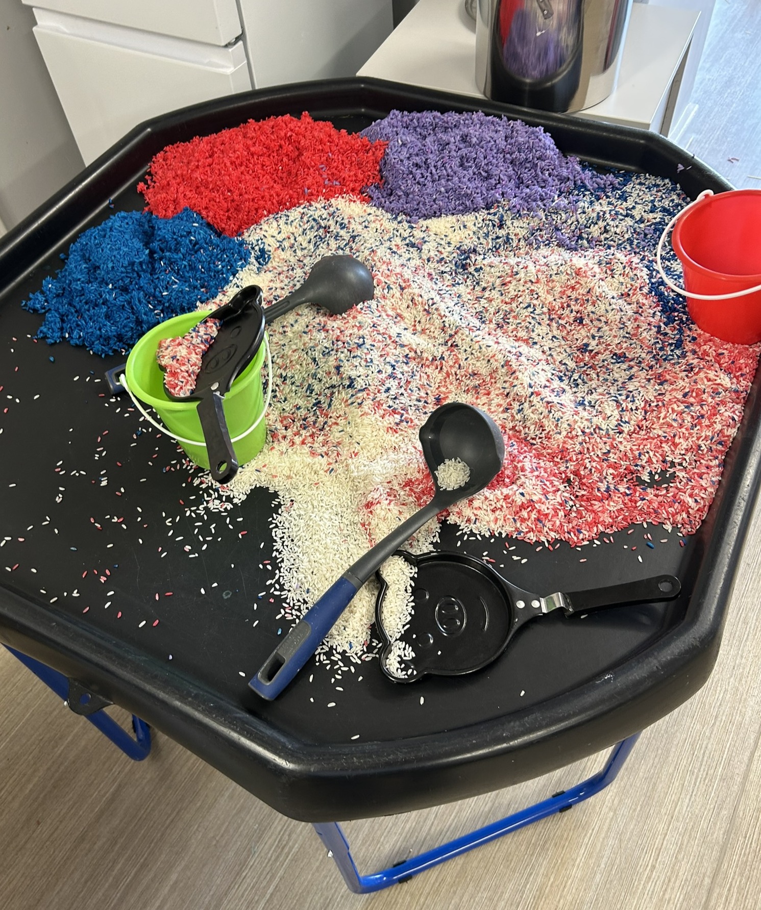coloured rice on a tuff tray