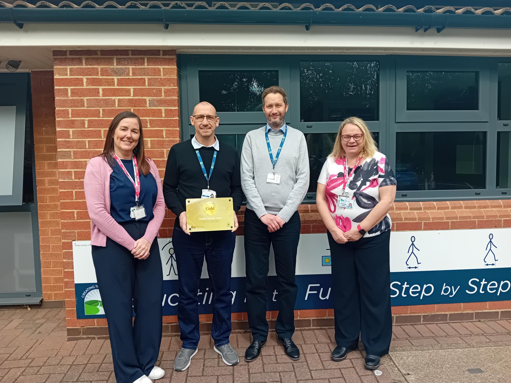 Healthy School Award being presented outside Wren Spinney to Mike and Toby