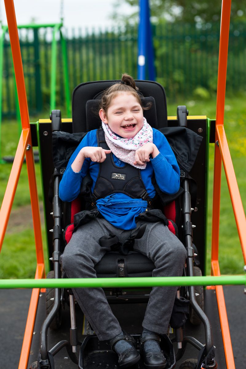 Girl in wheelchair on swing